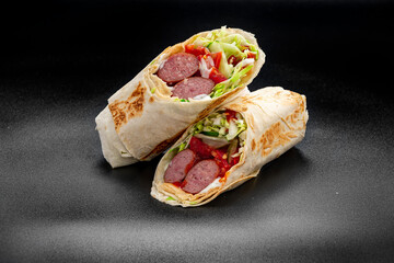 Shawarma with grilled sausage, vegetables and tomato sauce. Sausage in pita.