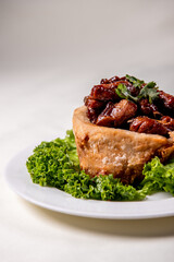 popular special wok fried sweet and sour pork ribs with deep fried yam ring on white wood table asian chinese banquet meat menu for restaurant 