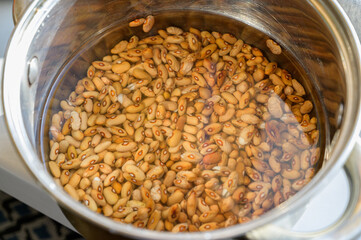 Beans are soaked in a pot for further cooking.