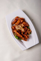 fresh wok fried sweet and sour pork chop chicken in Mongolian style on wood table background asian Chinese halal banquet meat menu for restaurant