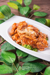 fresh wok fried sweet and sour pork chop chicken in Mongolian style on wood table background asian Chinese halal banquet meat menu for restaurant