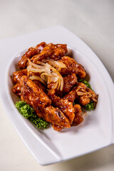 fresh wok fried sweet and sour pork chop chicken in Mongolian style on wood table background asian Chinese halal banquet meat menu for restaurant