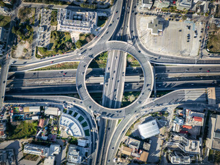 Aerial top view of multilevel junction ring road as seen in Attiki Odos toll road motorway...
