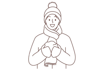 Smiling man with snowball in hands 