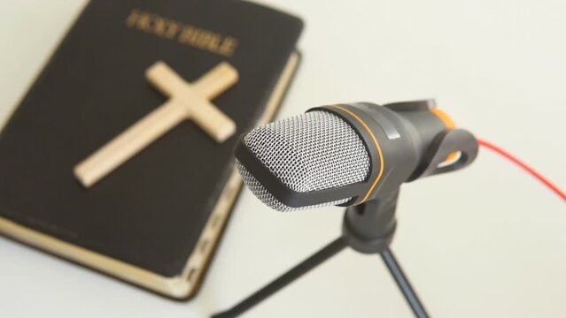 Bible book with microphone. Christian radio broadcast. Man records a podcast.