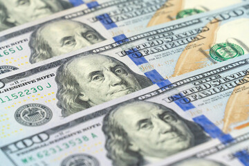 Macro photography of 100 dollar bills in a row. International currency. Background of dollar bills.