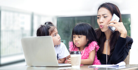 Mother is busy working and taking care of her children during the semester break. Mother is busy working and taking care of her children in summer break school to take care her family with working