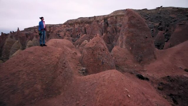 Orbit Drone View. Caucasian Woman Tourist Enjoy Freedom Between Fairy Chimneys In Devrent Valley, Cappadocia.