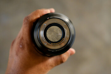 person holding a camera lens