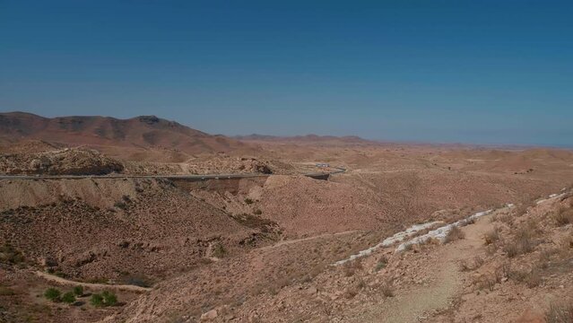 Panoramic view of the desert from left to right in Matmata Africa. Large view of sand all over the place on sunny day in desert.