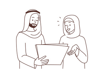 Smiling Arabic businesspeople discuss paperwork 