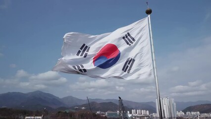 Aerial view of a giant south korean national flag named Taegeukgi waving in the wind near Ulsan station at 60fps, South Korea.