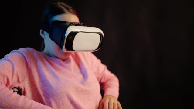 Young woman with disability wearing virtual reality headset, enjoying picture