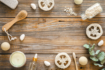Spa composition with body care items on wooden background, top view.