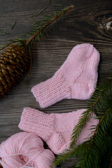 Fototapeta na wymiar Small and soft baby socks made of pink cotton yarn 