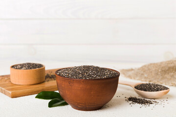 Chia seeds in bowl and spoon on colored background. Healthy Salvia hispanica in small bowl. Healthy superfood