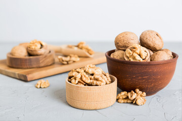 Fresh healthy walnuts in bowl on colored table background. Top view Healthy eating bertholletia concept. Super foods