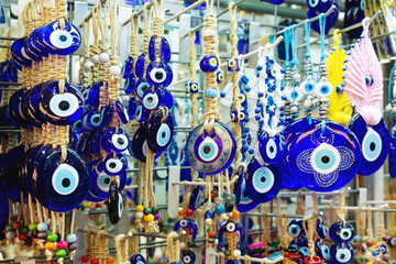 Traditional Turkish amulet Evil Eye or blue eye (Nazar boncugu). Souvenir of Turkey and traditional turkish amulet in the street shop, Istanbul, Turkey (Turkiye)