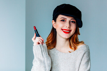woman in sweater and hat with lipstick