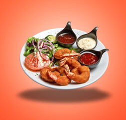 Floating White plate with roasted shrimps, sausage and salad