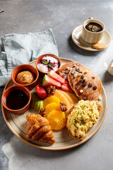 Traditional French Breakfast with toast, bread, egg, sauce, croissant, pineapple, strawberry, espresso coffee and cookies served in dish isolated on table top view of arabic breakfast
