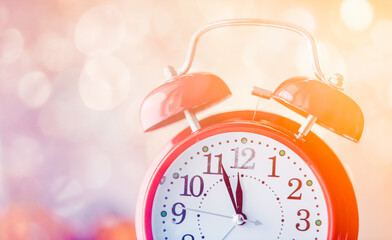Obraz na płótnie Canvas Vintage Alarm clock with Christmas gift and Ligths on background