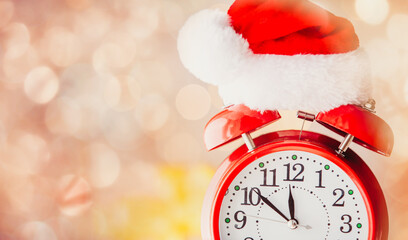Vintage Alarm clock in Santa Claus hat with Christmas gift