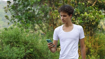 man in white shirt with mobile phone