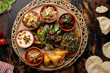bahrain iftar and breakfast platter with samosa, raita, salad, bread, fruit chaat served in dish isolated on table top view of arabic breakfast - obrazy, fototapety, plakaty
