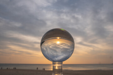 view of colorful nature at sunset inside crystal ball..beautiful sunset over sea in a crystal ball on the beach. .Nature High quality footage in nature and travel concept.