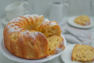 Lemon bundt cake drizzled with powdered sugar glaze