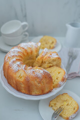 Lemon bundt cake drizzled with powdered sugar glaze