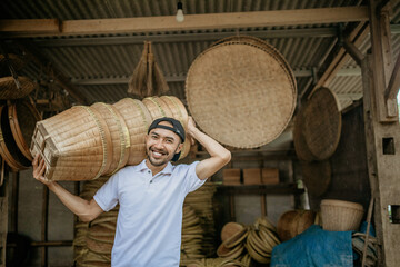 asian male seller carrying bamboo basket product in front of his shop