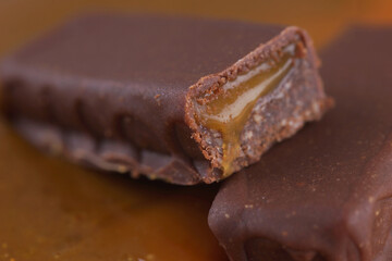 Sweet bar with caramel filling in caramel