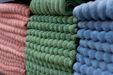 Soft focus close up shot of a stack of kitchen or bath towels on supermarket shelf