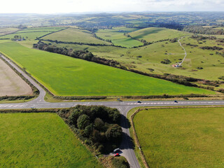 An aerial view of a staggered crossroads in a rural landscape