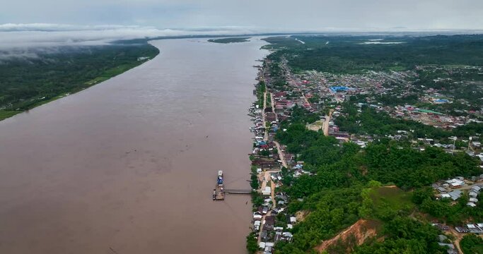 Contamana, Ucayali Province, Peru' - Small town city on the amazon river jungle rainforest isolated. 4k High resolution dronre fly view from above.