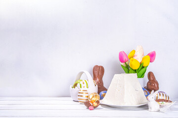 Traditional orthodox Easter paskha curd cake. Simple Easter vanilla cottage cheese dessert, with Easter eggs, spring flower and decorations copy space