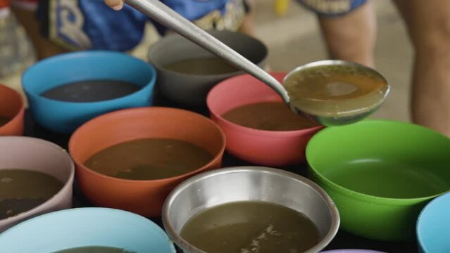 famine life live below the poverty line, Feeding the poor, food distribution with bowls of nourishing lentil soup