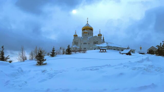 Belogorsky St. Nicholas Orthodox Missionary Monastery. Russia, Perm Krai, Belaya Gora. The temple on the hill in winter. Monastery on the background of snow. 4K