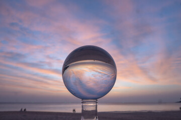 view of colorful nature at sunset inside crystal ball..beautiful sunset over sea in a crystal ball on the beach. .Nature High quality footage in nature and travel concept.