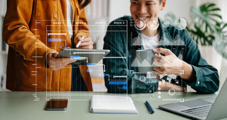 Businessman hand Project manager working and update tasks and Gantt chart scheduling virtual diagram.with smart phone, tablet and laptop in office..