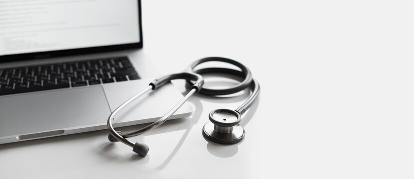Doctor stethoscope and laptop computer on white background, Healthcare and medical insurance industry, Doctor office desk panoramic banner with copy space