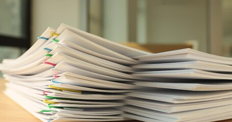 A stack of paper with colored paper clips, close-up