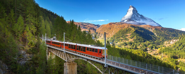 Zermatt, Switzerland. Gornergrat red tourist train on the bridge and Matterhorn peak panorama in Swiss Alps, benner - obrazy, fototapety, plakaty