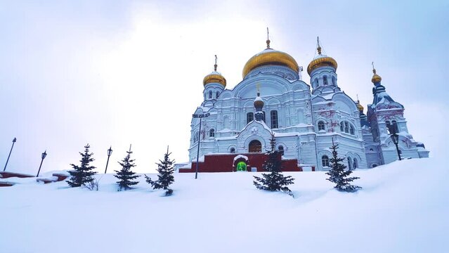 Belogorsky St. Nicholas Orthodox Missionary Monastery. Russia, Perm Krai, Belaya Gora. The temple on the hill in winter. Monastery on the background of snow. 4K