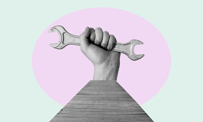 Art collage. Hand with a wrench with a wooden bridge.