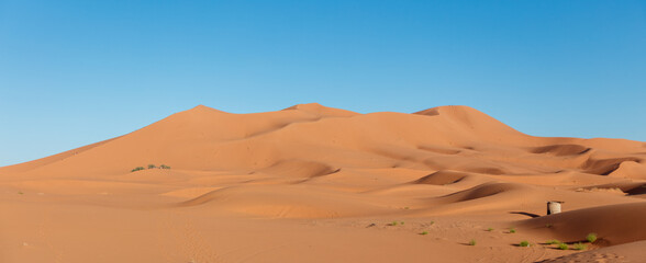 landscape of golden sand dune with blue sky- Sahara desert,  Morocco