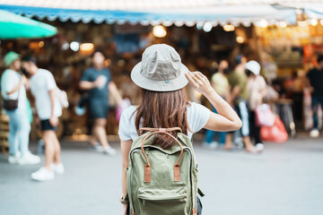 woman traveler visiting in Bangkok, Tourist with backpack and hat sightseeing in Chatuchak Weekend...