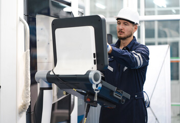 Industrial engineer operating modern CNC milling machine at a metalworking factory. Metalwork technician working with skill on accurate, precision automated machinery in lathe or cut steel. copy space